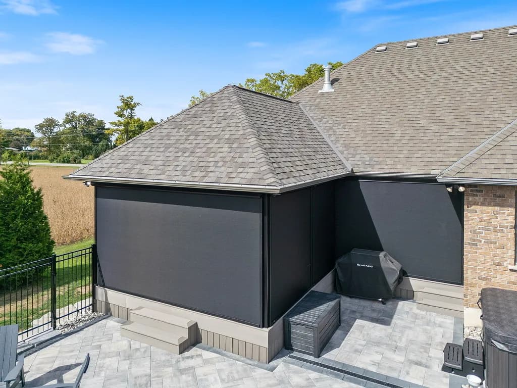Corner-deployed black insect mesh on a brick Ontario home