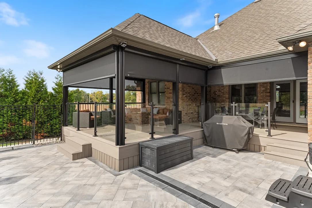 Brick home patio extension with multi-section deployed screens