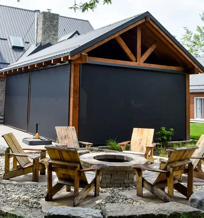 Timber pavilion with deployed Talius Fly Screens around fire pit