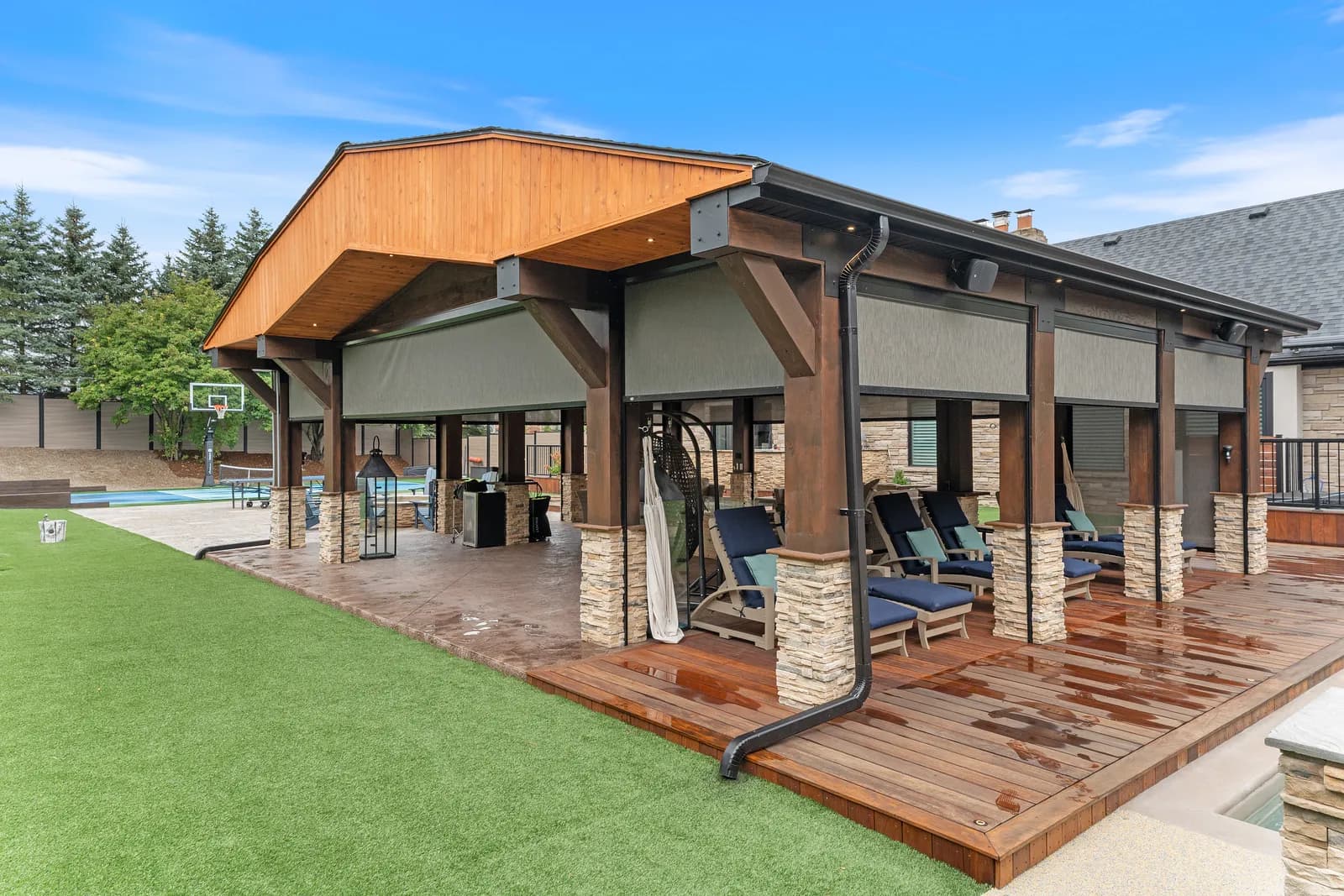 Pool cabana with deployed shades and basketball hoop