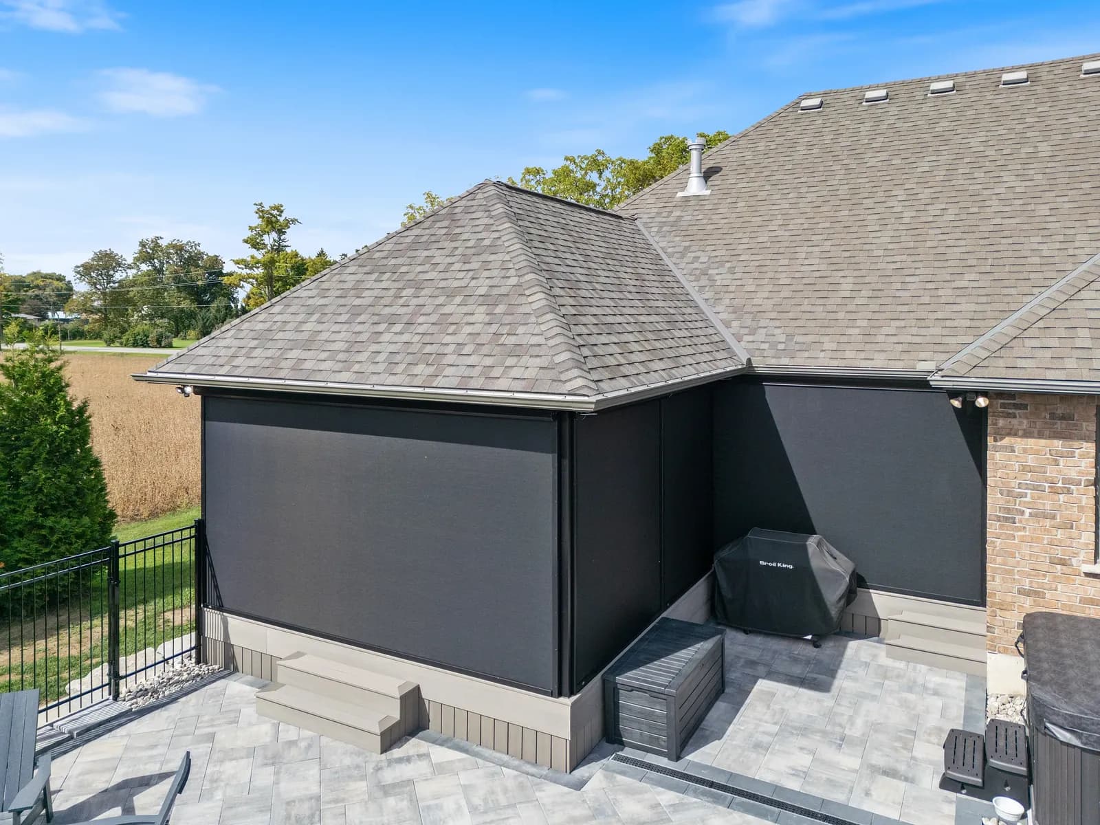 Stone home with corner-mounted retractable screens