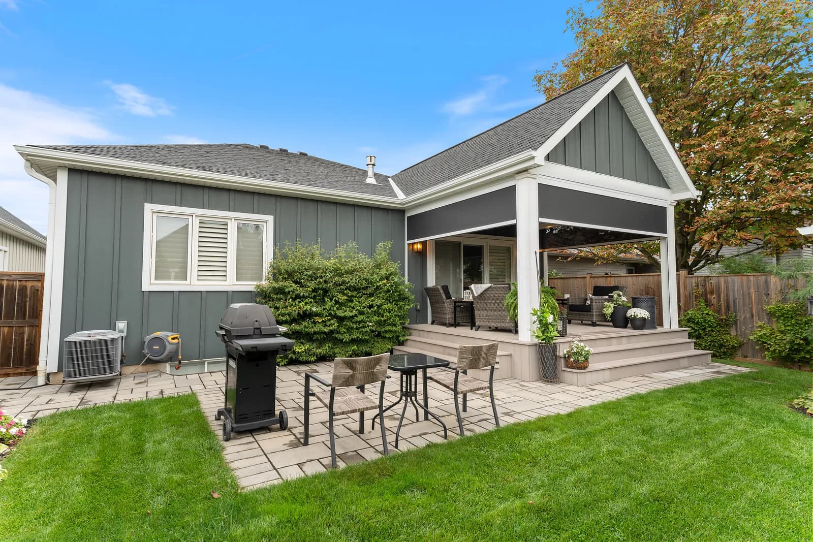 Suburban gable home with retractable screens hidden in the soffit of a covered porch